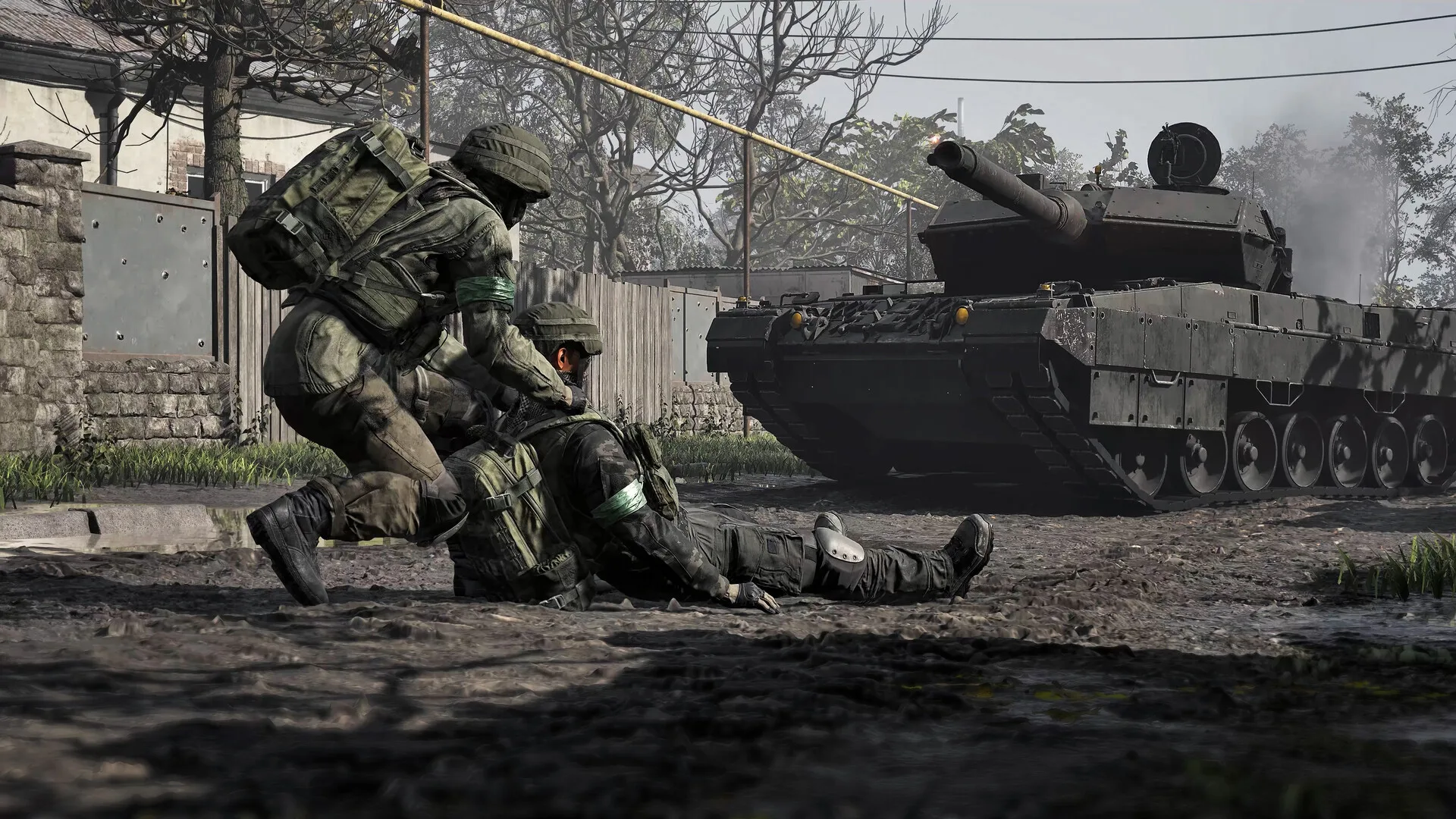 A WARDOGS soldier assists a downed teammate while a tank approaches on a village road.